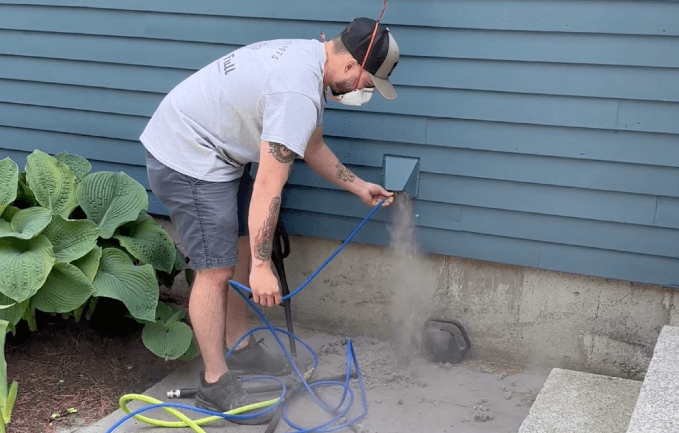 A-Vent-Full technician cleaning a dryer vent at ground level